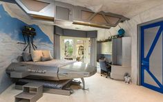 a bedroom decorated in blue and white with a metal bed, desk, stairs and storage area