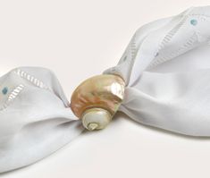 an image of a white bow with pearls on it