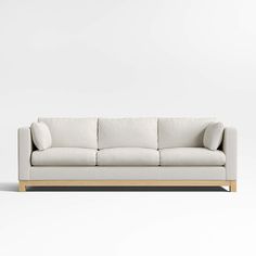 a white couch sitting on top of a wooden frame