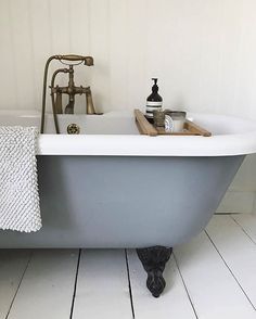 an old fashioned bathtub in a white bathroom