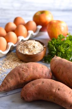 carrots, oatmeal, and eggs on a table with other ingredients