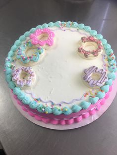 a decorated birthday cake with donuts on top