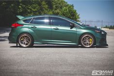 a green car parked in a parking lot