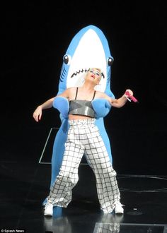 a woman in a shark costume on stage