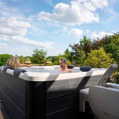 two people sitting in an outdoor hot tub