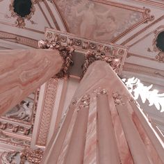 an ornately decorated ceiling in a pink and white room with gold trimmings