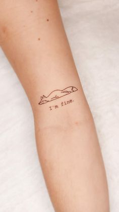 a woman's arm with a tattoo saying i'm fine