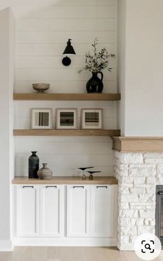 a living room filled with furniture and a fire place next to a wall mounted tv