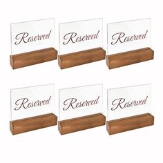 four clear acrylic business cards with wood base