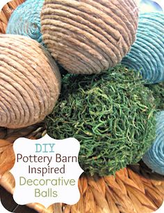 several balls of yarn sitting on top of each other in a basket with the words diy pottery barn inspired decorative balls