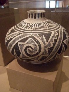 a black and white vase on display in a museum