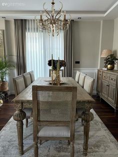 a dining room table with chairs and a chandelier