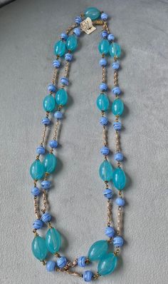 Rare Murano glass 1950s beaded necklace with original tag still on. Beautiful colour combination of aqua/green and light blue where 1" oval beads alternate with smaller round beads and polished metal chain. Original screw closure. Length: 26" or cm 66 closed, 52" or cm 132 open. Ideal gift for a lady who appreciates rare and fine things or....for yourself! Vintage Turquoise Single Strand Beaded Necklace, Blue Glass Beaded Chain Jewelry, Vintage Turquoise Single Strand Necklace, Vintage Glass Beaded Necklaces With Oval Beads, Turquoise Single Strand Glass Jewelry, Retro Beaded Chain Jewelry With Round Beads, Vintage Blue Double Strand Jewelry, Vintage Blue Single Strand Necklace, Vintage Multi-strand Turquoise Jewelry