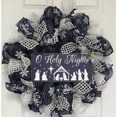 New, full, premium handmade deco mesh Christmas wreath. A large, wood navy blue sign with the wording “O Holy Night” rests on a bedding of beautiful, shimmering navy blue and silver deco mesh. The accent depicts a bright white nativity scene has an adorable snowflake ribbon with holly. Beautiful navy blue ribbons with the wording “silent night holy night” surround the center along with snowflake ribbons. White chenille window pane ribbons also surround the sign. The outer ring is decorated with Disney Wreath, Silent Night Holy Night, Deco Mesh Christmas Wreaths, Christmas Mesh Wreaths, Blue Wreath, O Holy Night, Xmas Wreaths, Bright Christmas, Religious Christmas