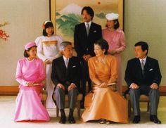 a group of people sitting next to each other in front of a painting on the wall