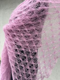 a close up of a pink shawl on a mannequin