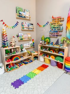 a child's playroom with toys, bookshelves and rainbow rugs