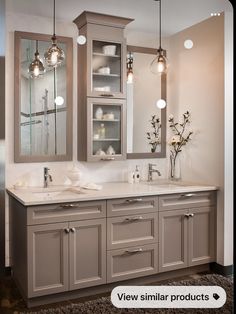 a bathroom with double sinks and two mirrors on the wall next to eachother