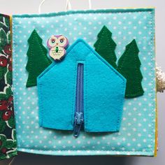 a small blue house with an owl on it