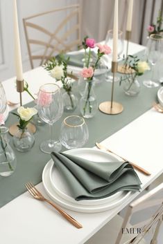 the table is set with flowers and place settings for two people to sit down at