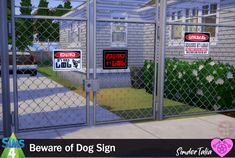 a fenced in area with signs on it that say beware of dog sign