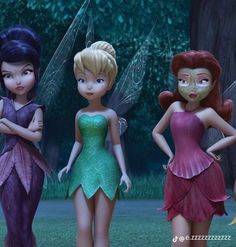 four fairy - like girls standing next to each other in front of some trees and grass