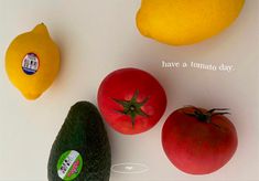 tomatoes, avocado and lemons are arranged on a white surface with the words have a tomato day