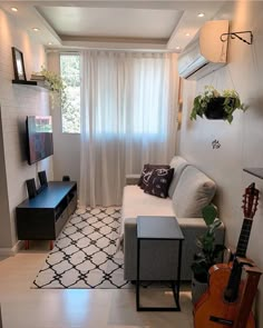 a living room filled with furniture and a flat screen tv on top of a wall