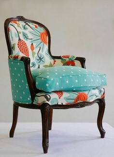 an upholstered chair with blue and white fabric