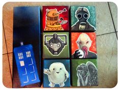 the doctor who themed coasters are next to each other on the tile in front of a phone booth