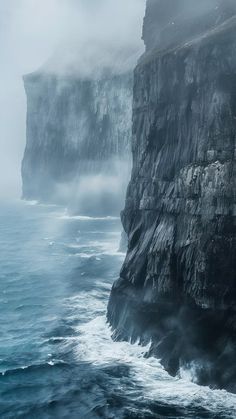 the cliffs are covered in fog and water