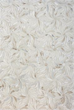 a white rug with leaves on it