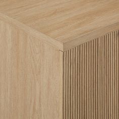 a close up view of the top of a wooden cabinet with vertical slats on it