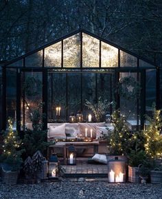 a living room filled with lots of furniture and lit candles