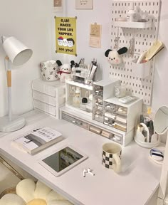 a white desk topped with lots of clutter