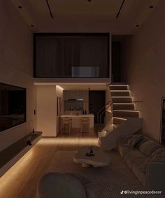 a living room filled with furniture next to a stair case in a house at night