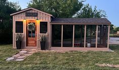 a small shed with a door and windows