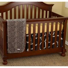 a baby crib with a blanket on top of it