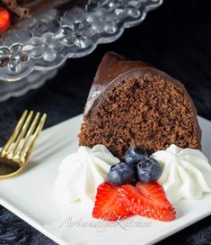 a slice of chocolate cake with whipped cream and strawberries