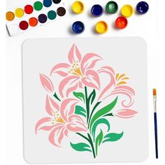 a white mouse pad with pink flowers on it next to watercolors and paint