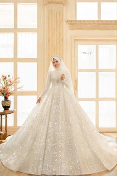 a woman in a white wedding dress posing for the camera