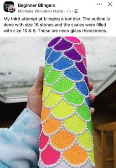 someone is holding up a case made out of beads