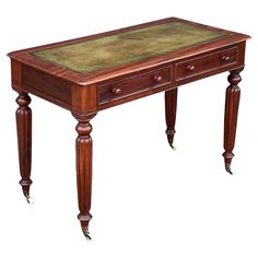 an antique desk with green leather top and wooden legs, on display against a white background