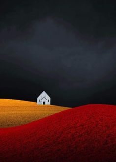 a white house sitting on top of a hill under a cloudy sky with red flowers