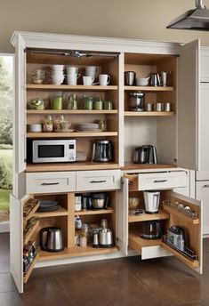 an open cabinet in the middle of a kitchen