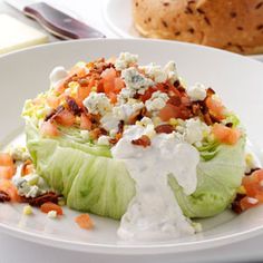 a white plate topped with lettuce covered in ranch dressing