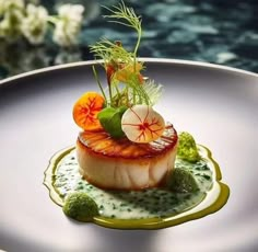 a white plate topped with food on top of a green sauce covered table next to water