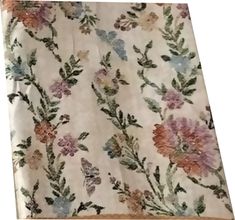 an image of a flowered fabric with leaves and flowers on the side, as well as