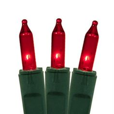 three green christmas lights with red bulbs on each one's head and two are facing the same direction