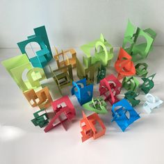 several different colored pieces of paper sitting on top of a white table next to each other